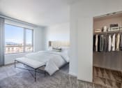 Thumbnail 41 of 104 - A bedroom with a large bed and a wardrobe at The Grand Apartments, California, 94612